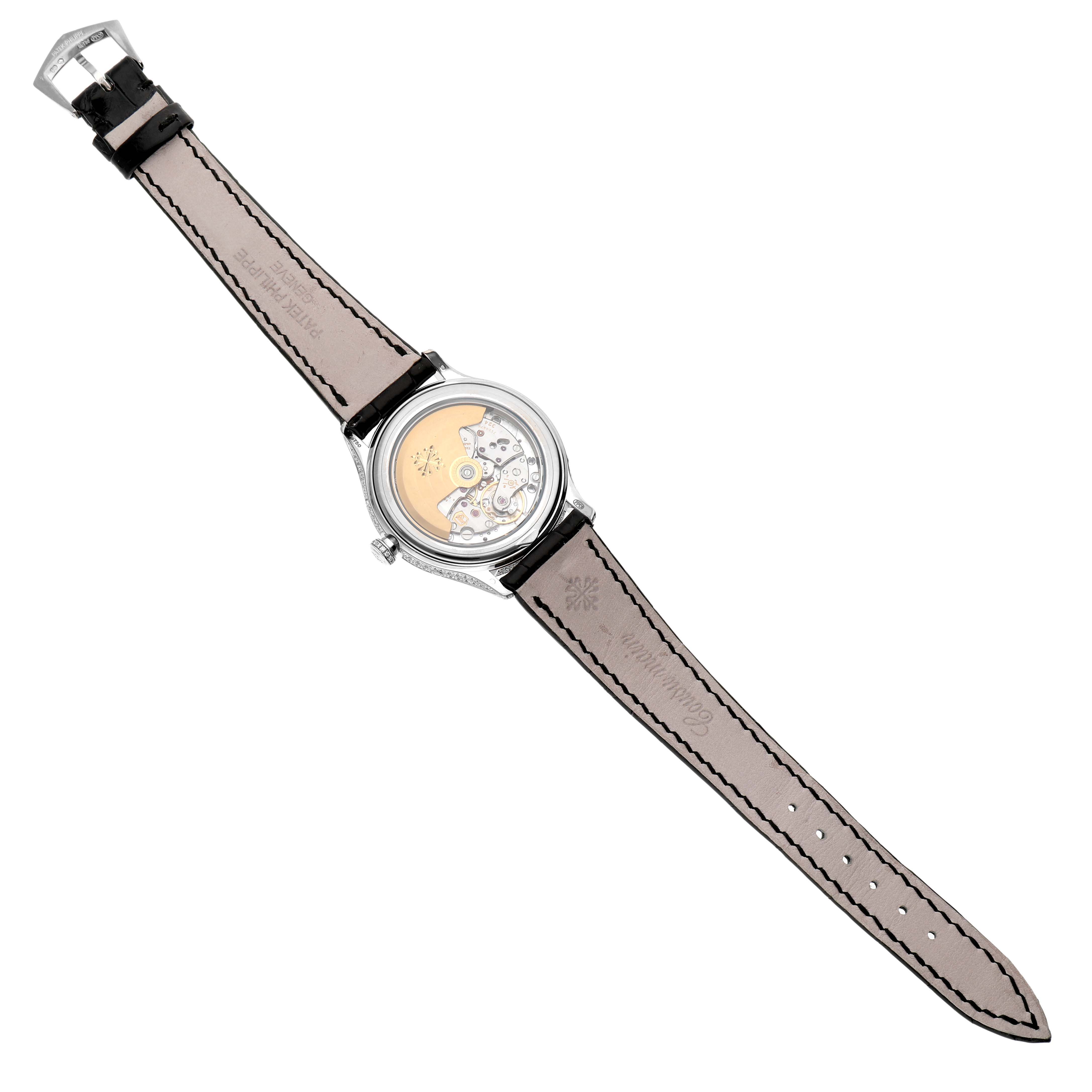 The image shows the Patek Philippe Complications 4948G Men's White Gold Mother of Pearl Dial watch from the back, revealing the movement and leather strap with stitching.