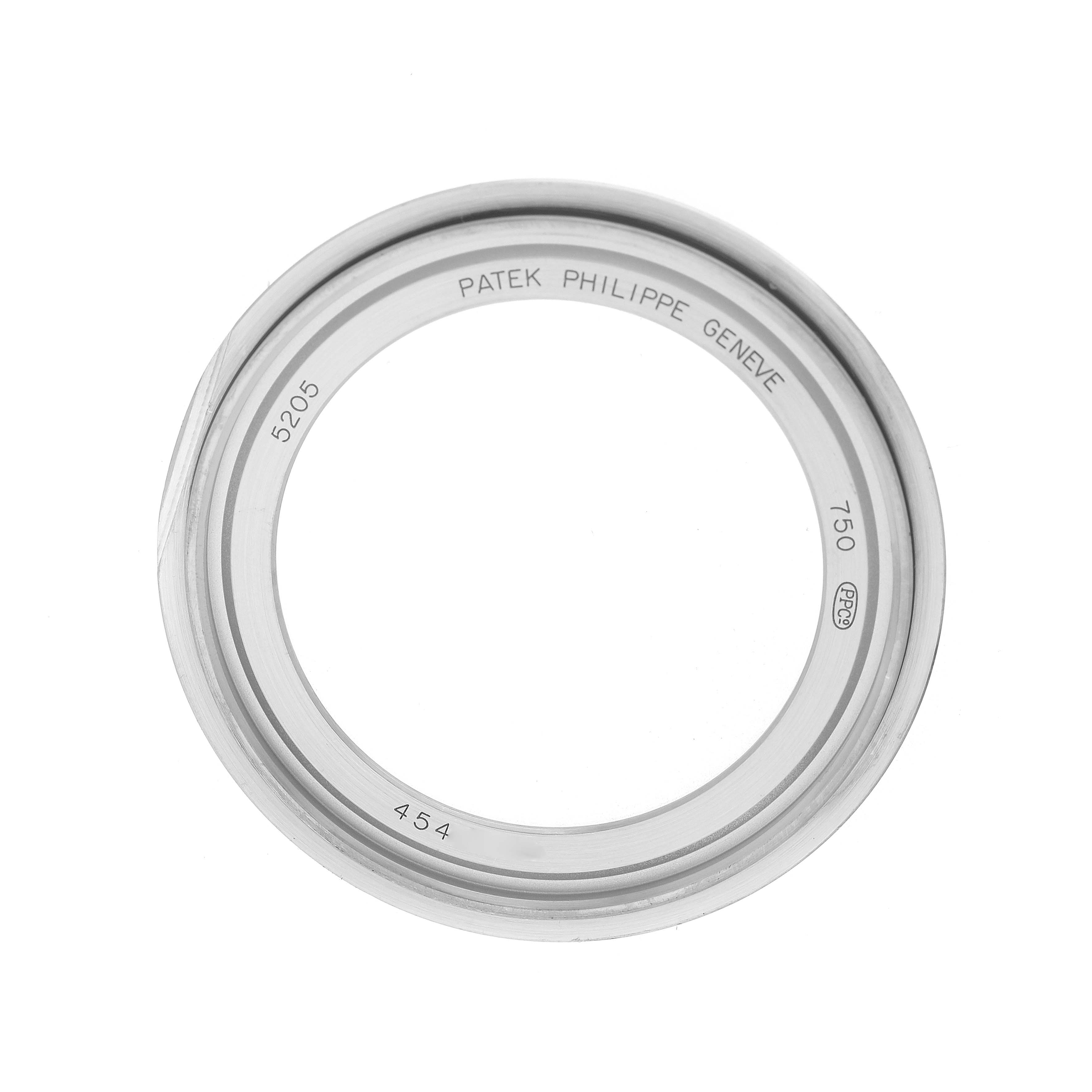The image shows a Patek Philippe Complications 5205G Men's White Gold Silver Dial model bezel, viewed from above, featuring engravings like "5205."