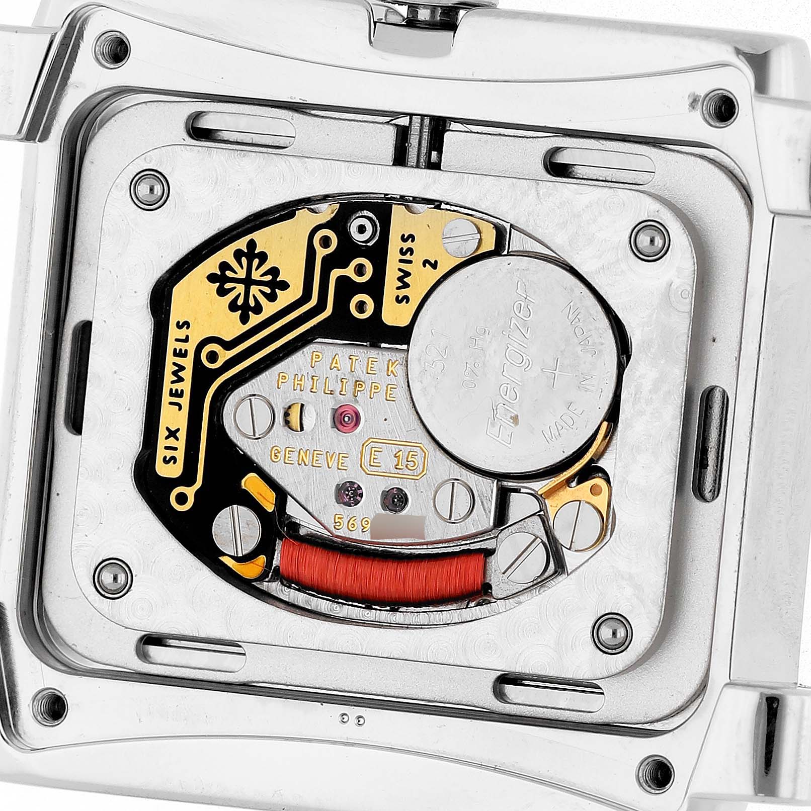 The image shows the movement and battery compartment of a Patek Philippe Twenty-4 4910/10A-010 Women's Stainless Steel Grey Dial watch from the back view.