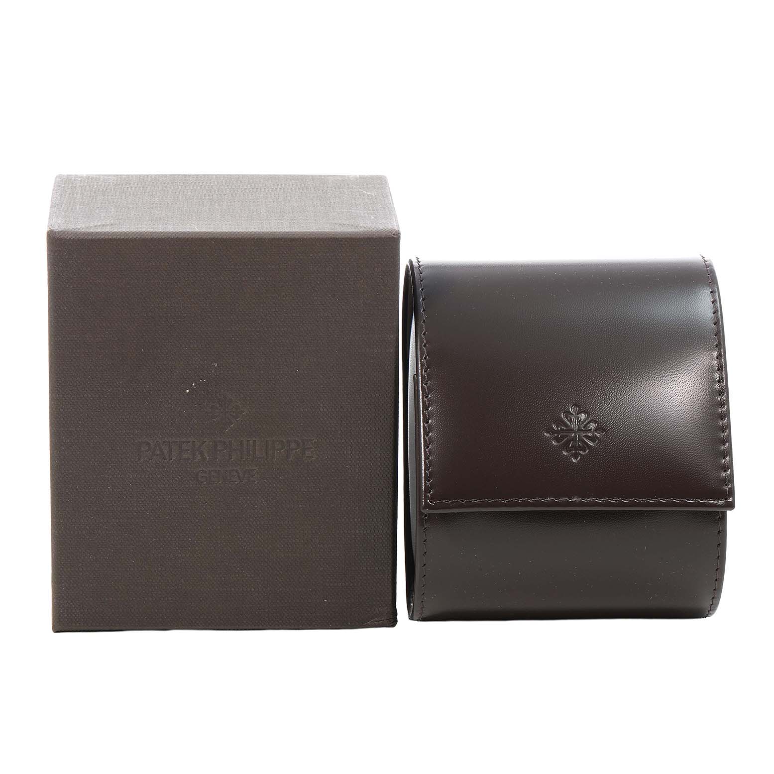 The image shows a Patek Philippe Twenty-4 4910/10A-010 Women's Stainless Steel Grey Dial watch box and a leather case from a front angle.
