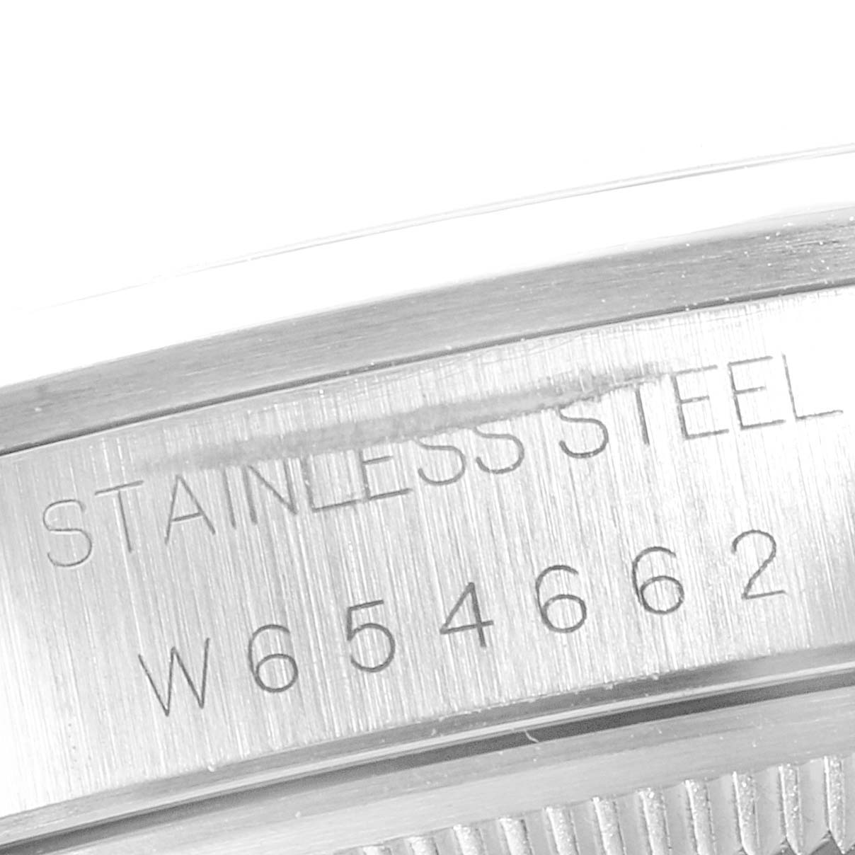 This close-up shot shows the serial number and "STAINLESS STEEL" engraving on the case of a Rolex Date 15200 Men's Stainless Steel Silver Dial 15200 Men's Stainless Steel Silver Dial model watch.