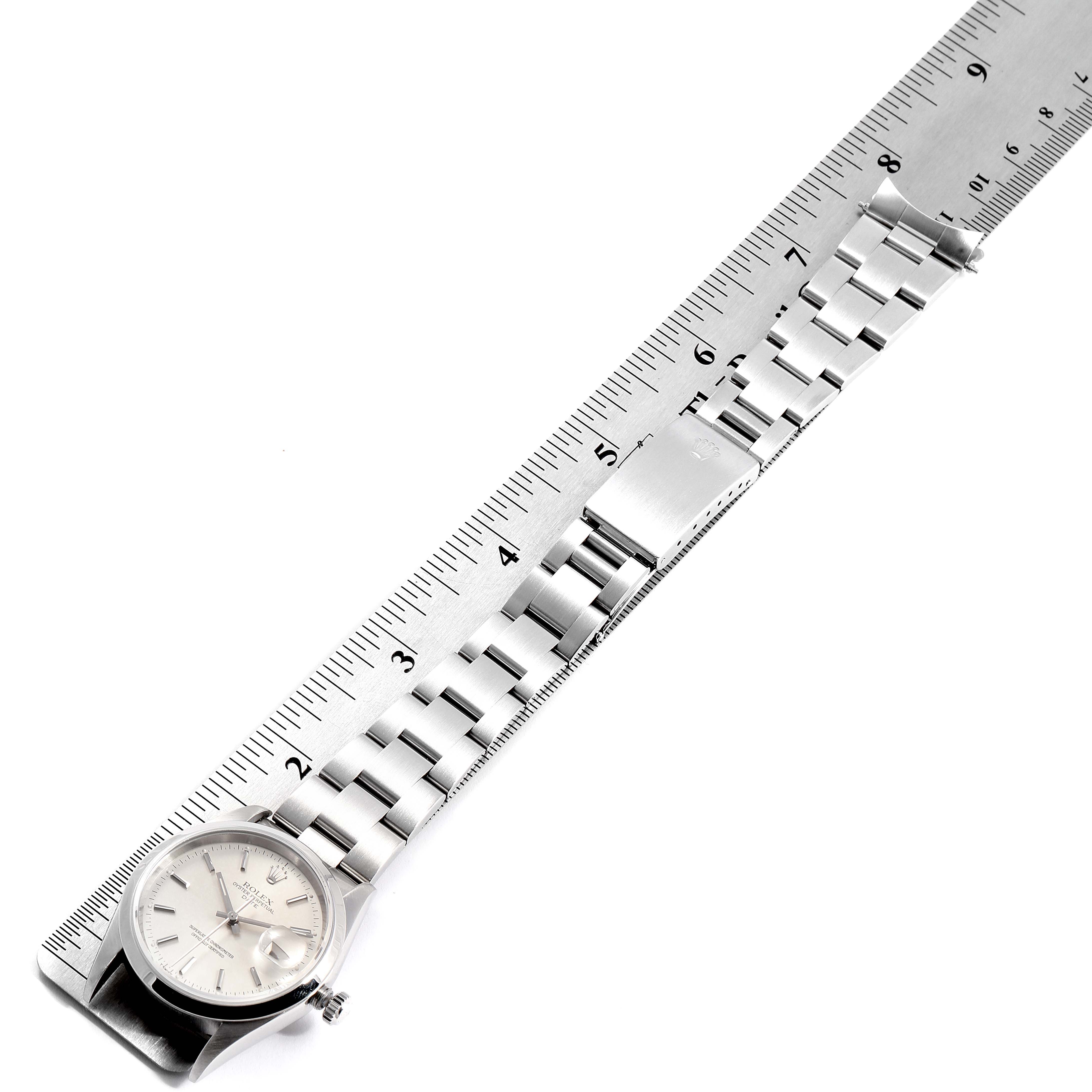 The image shows a top-down view of a Rolex Date 15200 Men's Stainless Steel Silver Dial 15200 Men's Stainless Steel Silver Dial model watch, including the face, crown, and entire metal bracelet measured with a ruler.