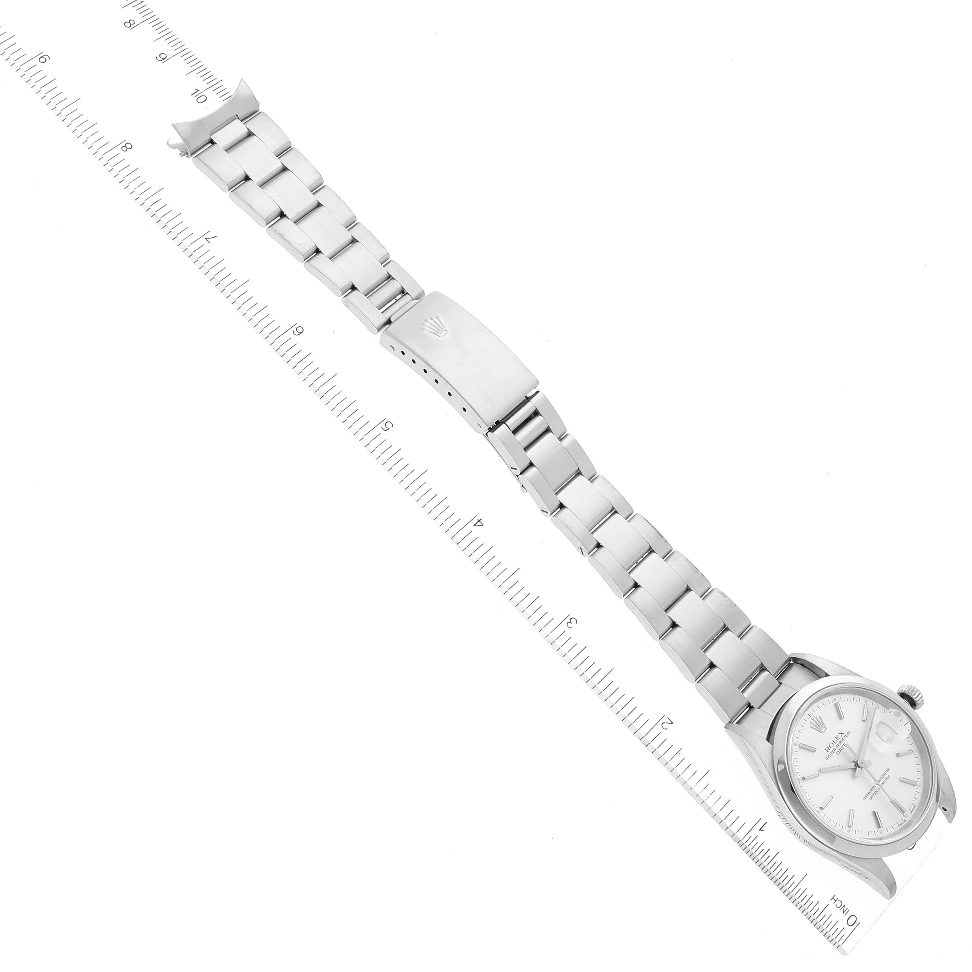 The image shows a top-down view of a Rolex Date 15200 Men's Stainless Steel Silver Dial 15200 Men's Stainless Steel Silver Dial model watch with its bracelet and clasp aligned next to a ruler.