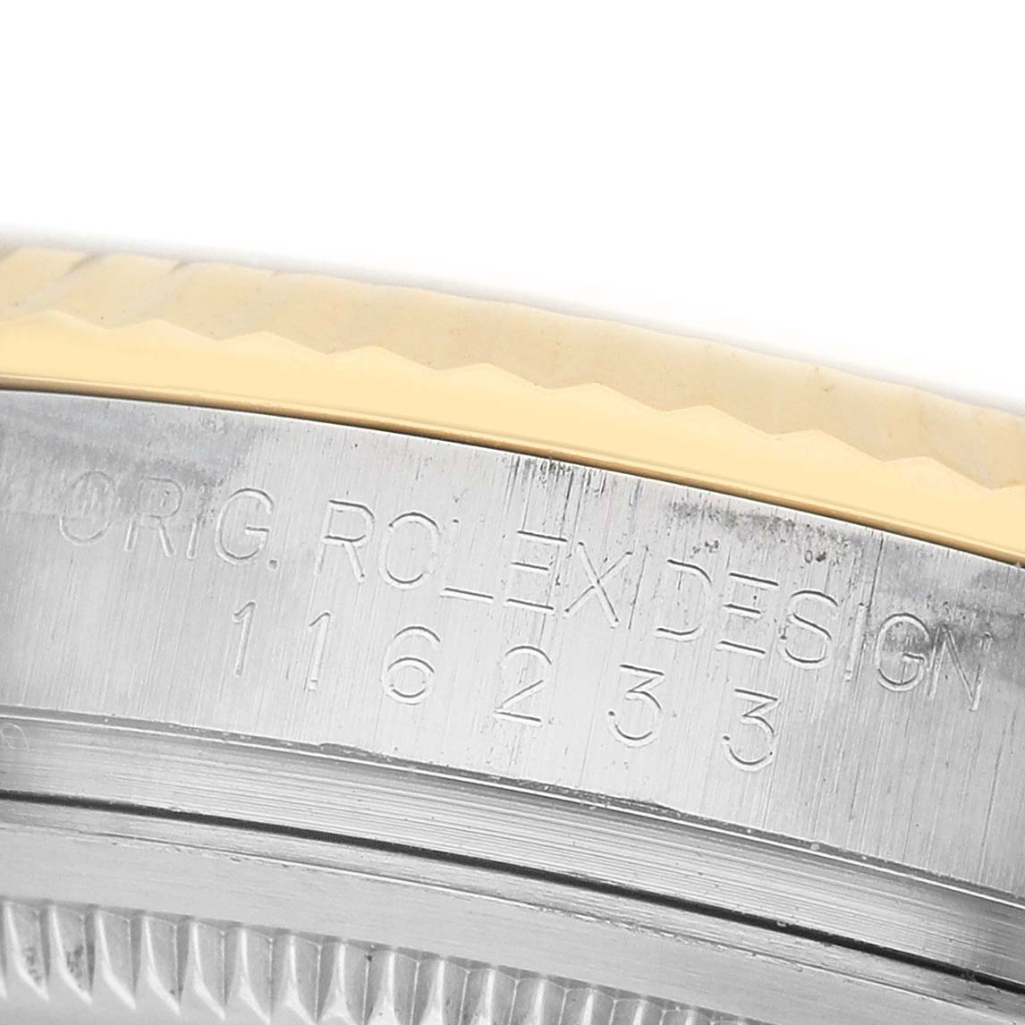 The image shows a close-up of the bezel edge and engraved details on the case of a Rolex Datejust 116233 Men's Steel and Gold (two tone) White Dial watch.