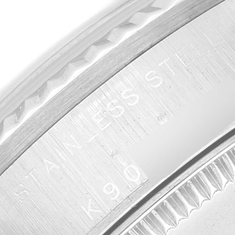 The image shows a close-up of the stainless steel outer edge and engravings on a Mid-Size Rolex watch.