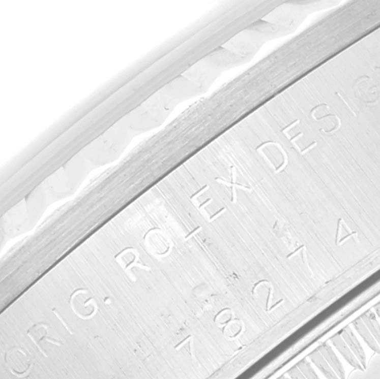 This image shows a close-up of the engraved bezel of a Rolex Mid-Size 78274 Women
s Stainless Steel Mother of Pearl Dial 78274 Women
s Stainless Steel Mother of Pearl Dial model watch.