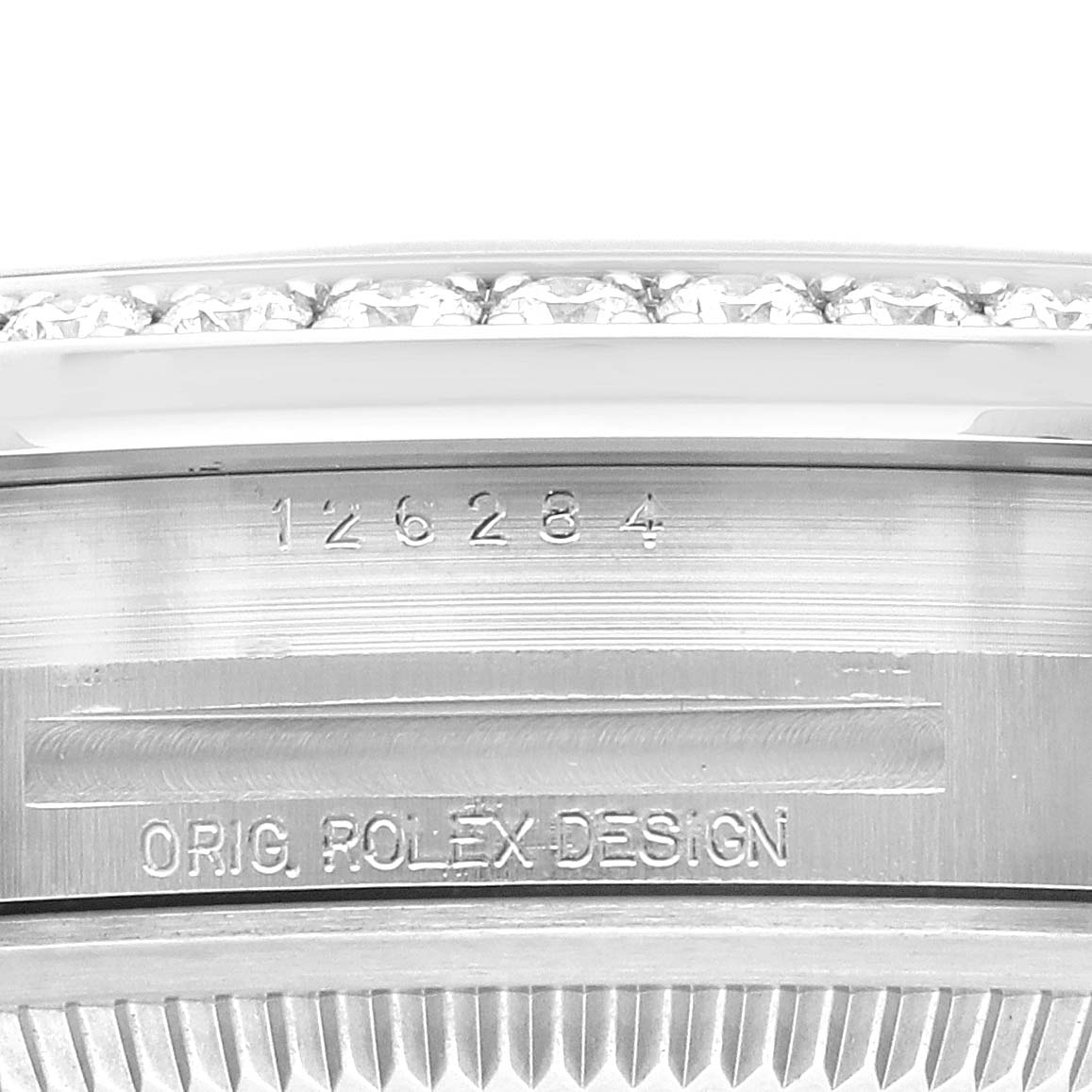 This close-up shows the serial number and "ORIG. ROLEX DESIGN" engraving on the side of a Rolex Datejust 126284RBR Men's Stainless Steel Blue Dial 126284RBR Men's Stainless Steel Blue Dial watch.