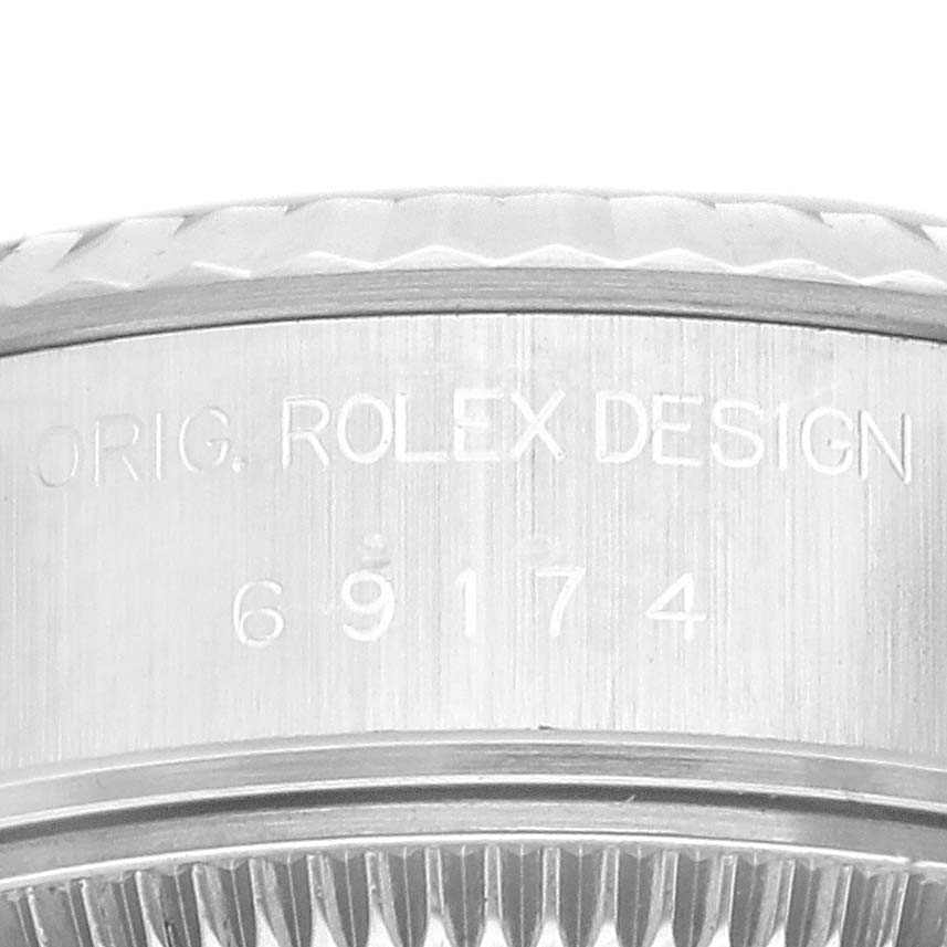 This close-up image shows the engraved details on the side of a Rolex Datejust 69174 Women's Stainless Steel Silver Dial 69174 Women's Stainless Steel Silver Dial bezel.