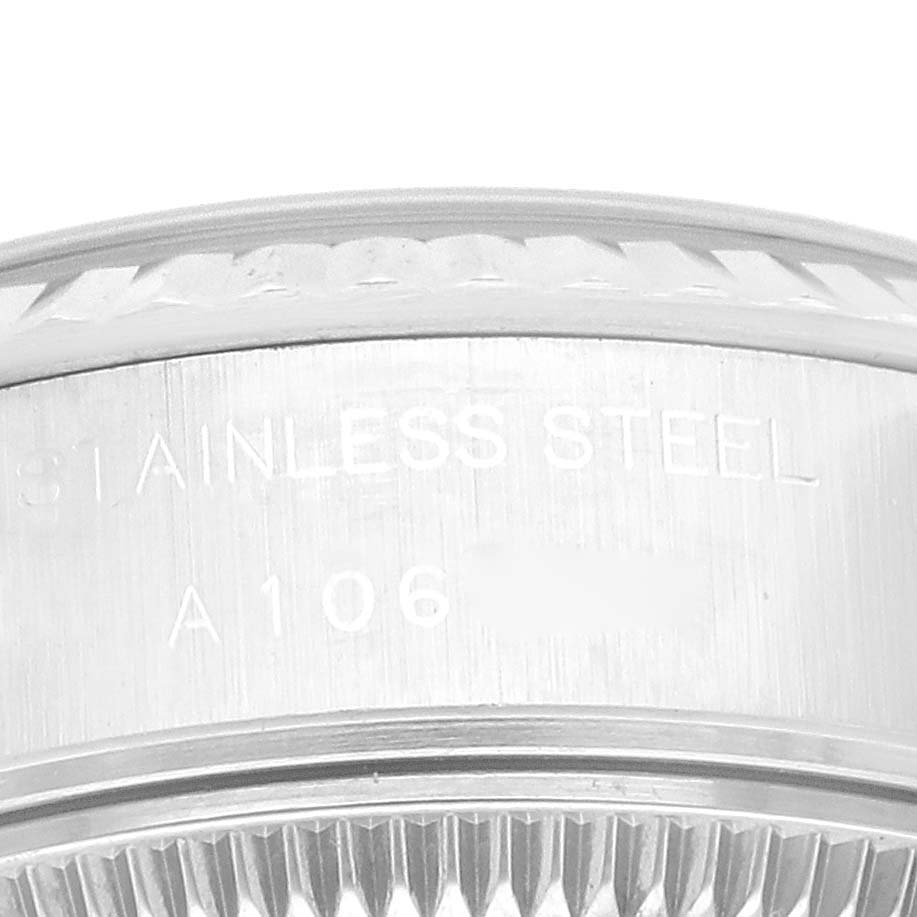 This image shows a close-up of the stainless steel case back and fluted bezel of a Rolex Datejust 69174 Women's Stainless Steel Silver Dial 69174 Women's Stainless Steel Silver Dial watch.