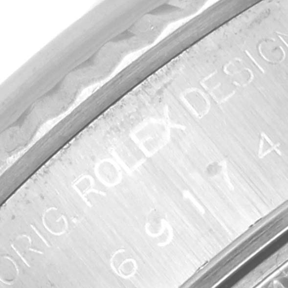 The image shows an angled close-up of the engraving on the side of a Rolex Datejust 69174 Women's Stainless Steel Pink Dial 69174 Women's Stainless Steel Pink Dial watch, displaying the branding and design identification.
