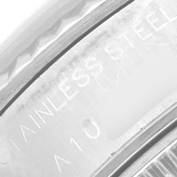 The image shows a close-up of the engraved text on the case back of a Rolex Datejust 69174 Women's Stainless Steel Pink Dial 69174 Women's Stainless Steel Pink Dial watch, highlighting "Stainless Steel."
