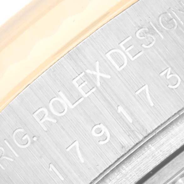 Close-up of the Rolex Datejust 179173 Women's Steel and Gold (two tone) Silver Dial 179173 Women's Steel and Gold (two tone) Silver Dial model, showing part of the case with engraved design details.
