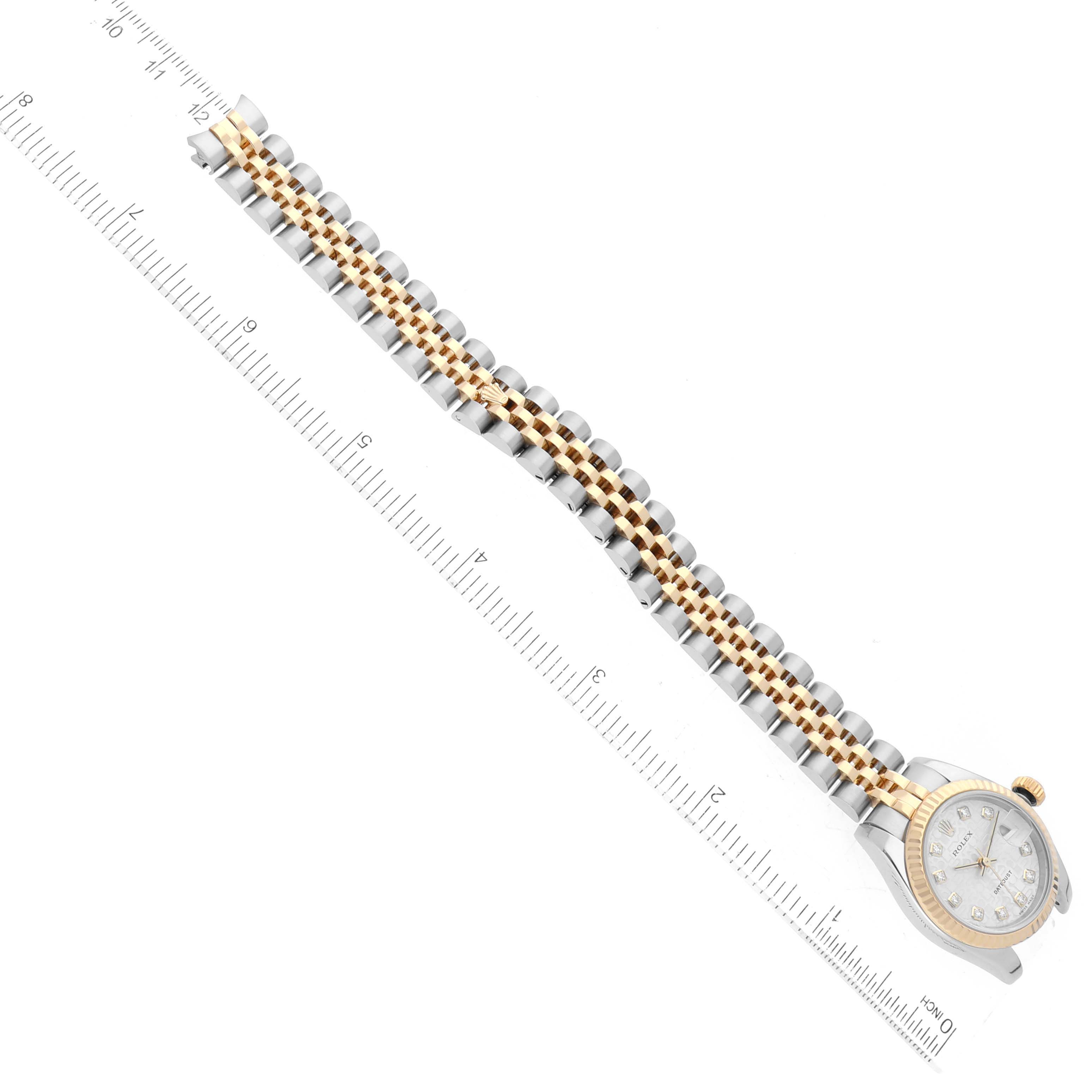 The image shows a bird's-eye view of a Rolex Datejust 179173 Women's Steel and Gold (two tone) Silver Dial 179173 Women's Steel and Gold (two tone) Silver Dial watch with a two-tone bracelet aligned next to a ruler.