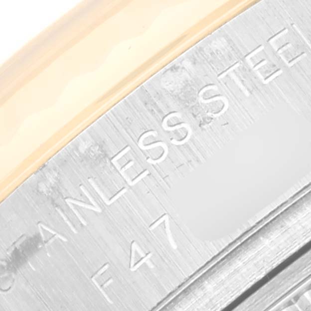 The image shows a close-up of the side of the stainless steel case and bezel of a Rolex Datejust 179173 Women's Steel and Gold (two tone) Silver Dial 179173 Women's Steel and Gold (two tone) Silver Dial watch.