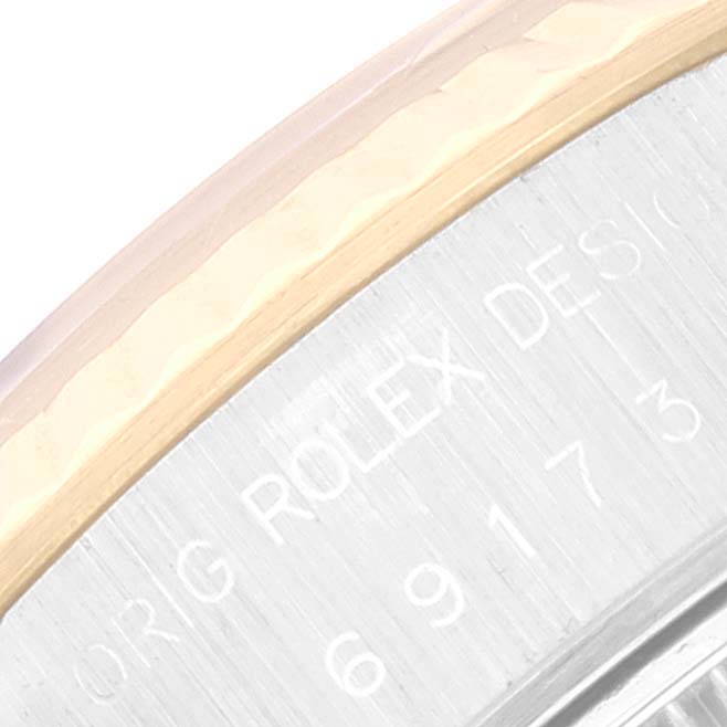 This image shows a close-up of the engraved side of a Rolex Datejust 69173 Women's Steel and Gold (two tone) Champagne Dial 69173 Women's Steel and Gold (two tone) Champagne Dial watch case.