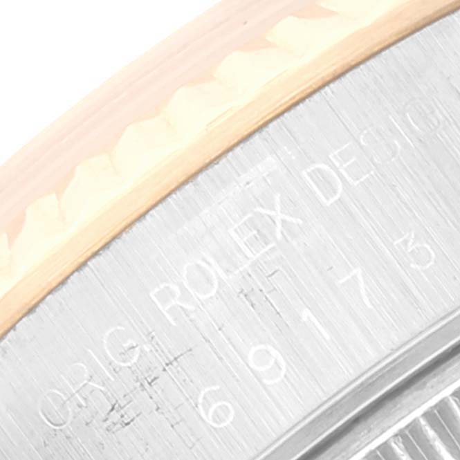 This image shows a close-up of the side part of a Rolex Datejust 69173 Women's Steel and Gold (two tone) Champagne Dial 69173 Women's Steel and Gold (two tone) Champagne Dial watch, highlighting the engraved "ORIG. ROLEX DESIGN" text and partial serial number.