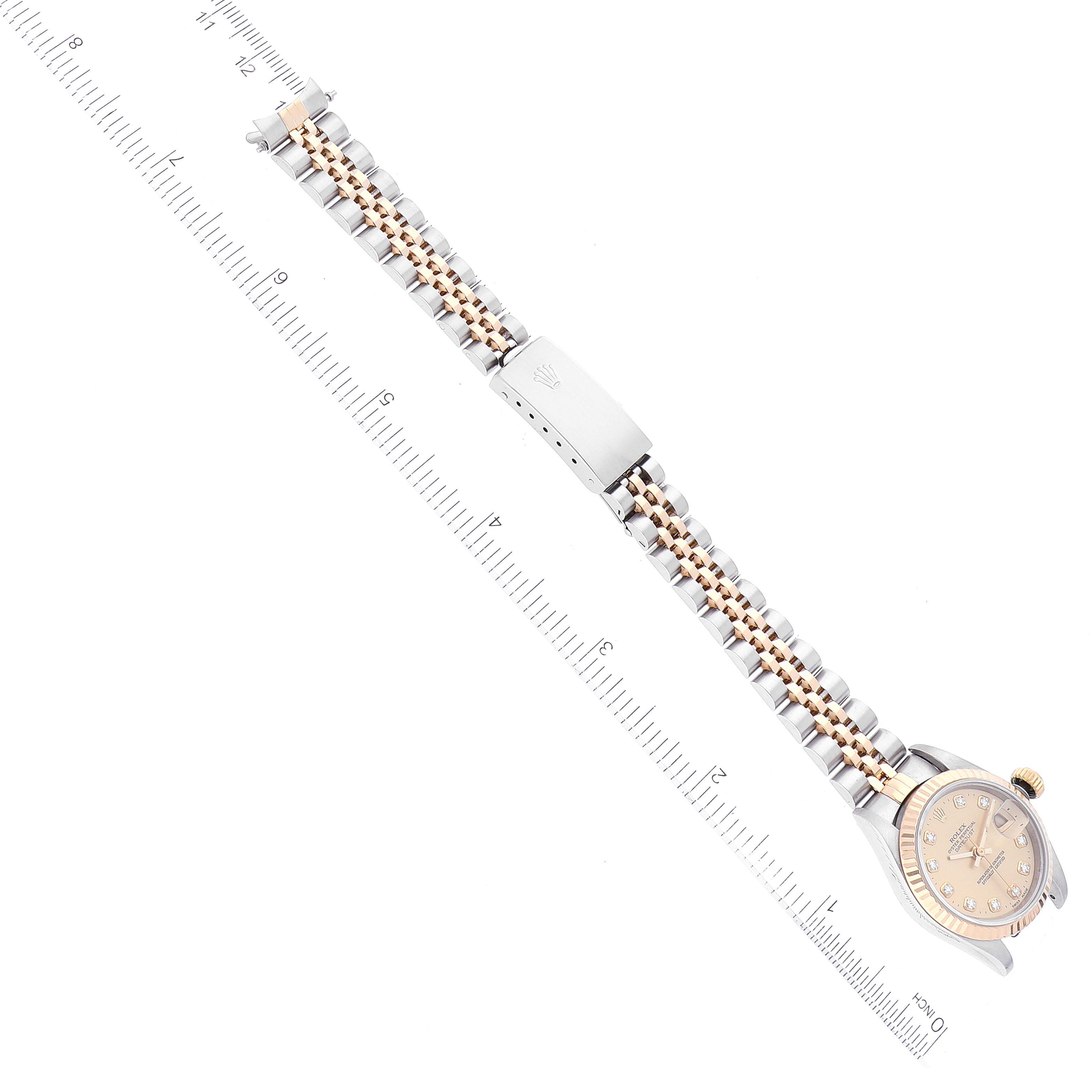 The image shows a top-down view of a Rolex Datejust 69173 Women's Steel and Gold (two tone) Champagne Dial 69173 Women's Steel and Gold (two tone) Champagne Dial watch with a focus on its bracelet and a portion of the dial.