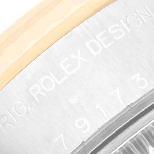 The image shows a close-up of the casing back edge, featuring engraved text with the brand and design number of the Rolex Datejust 79173 Women's Steel and Gold (two tone) White Dial 79173 Women's Steel and Gold (two tone) White Dial model.