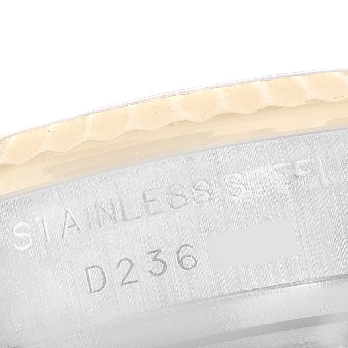 The image shows a close-up angle of the stainless steel casing with serial numbers on a Rolex Datejust 179173 Women's Steel and Gold (two tone) Mother of Pearl Dial 179173 Women's Steel and Gold (two tone) Mother of Pearl Dial watch bezel.
