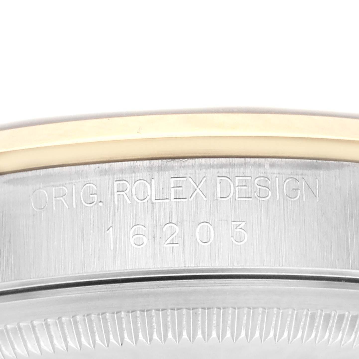 The image shows the side view of a Rolex Datejust 16203 Men
s Steel and Gold (two tone) Grey Dial 16203 Men
s Steel and Gold (two tone) Grey Dial watch case, focusing on the bezel and the engraved model number.