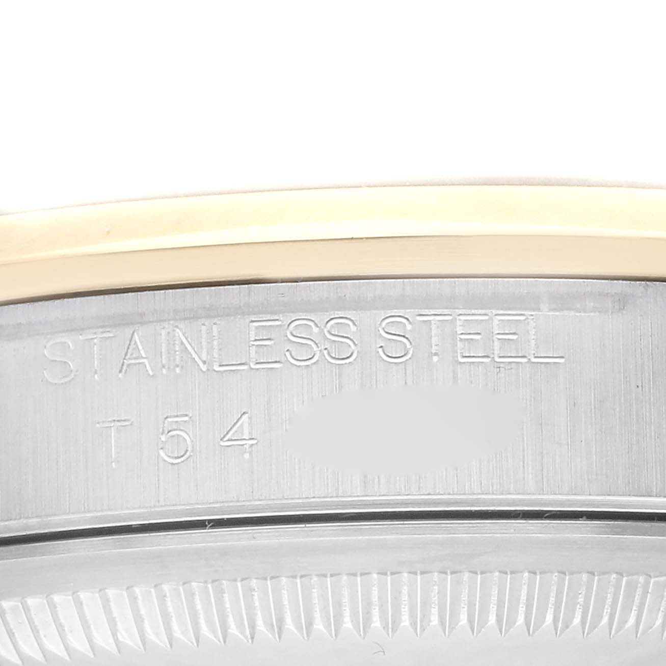 This close-up image shows the side of a Rolex Datejust 16203 Men
s Steel and Gold (two tone) Grey Dial 16203 Men
s Steel and Gold (two tone) Grey Dial watch case, displaying its stainless steel material and some engraved markings.