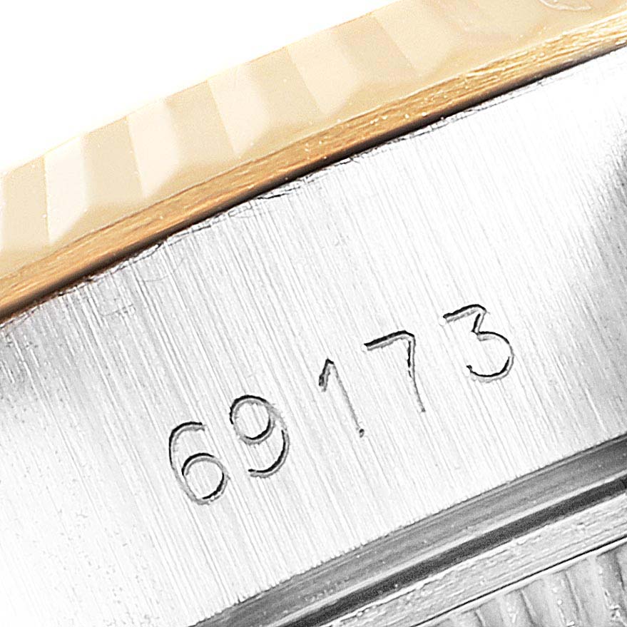 This close-up image shows the engraved model number "69173" on the case of a Rolex Datejust 69173 Women
s Steel and Gold (two tone) White Dial 69173 Women
s Steel and Gold (two tone) White Dial watch.