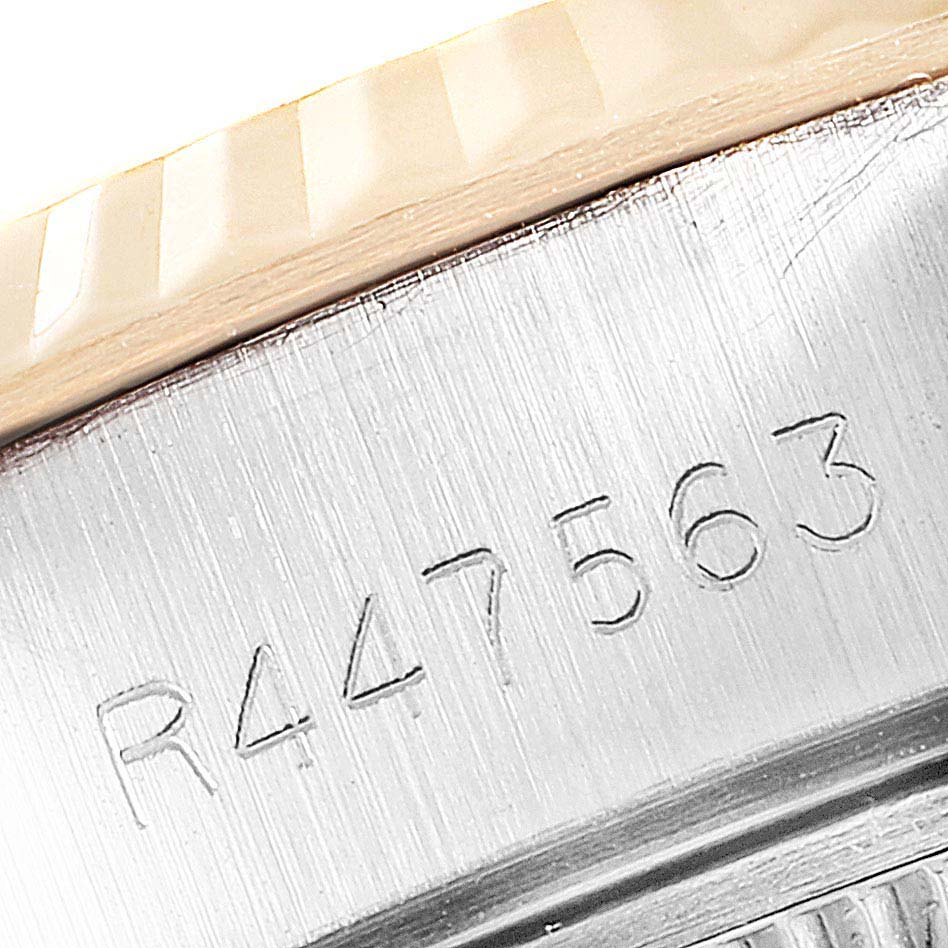 The image shows a close-up of a serial number engraved on the case of a Rolex Datejust 69173 Women
s Steel and Gold (two tone) White Dial 69173 Women
s Steel and Gold (two tone) White Dial watch.