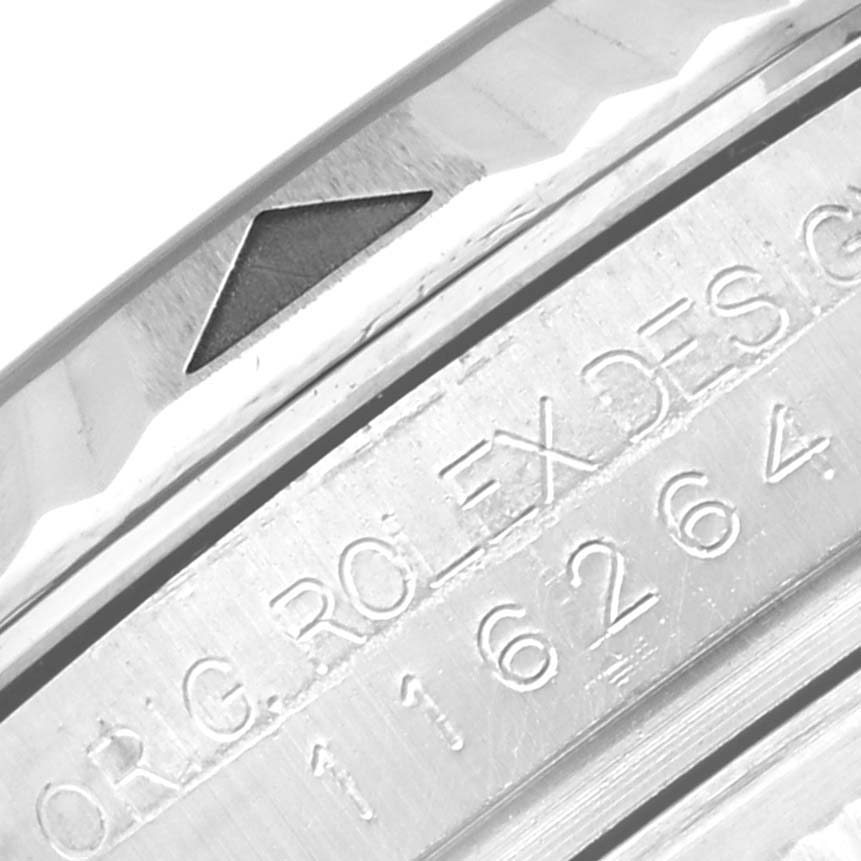 This image shows a close-up of the bezel and part of the engraved serial number on a Rolex Turn-o-Graph 116264 Men's Stainless Steel Black Dial 116264 Men's Stainless Steel Black Dial watch.