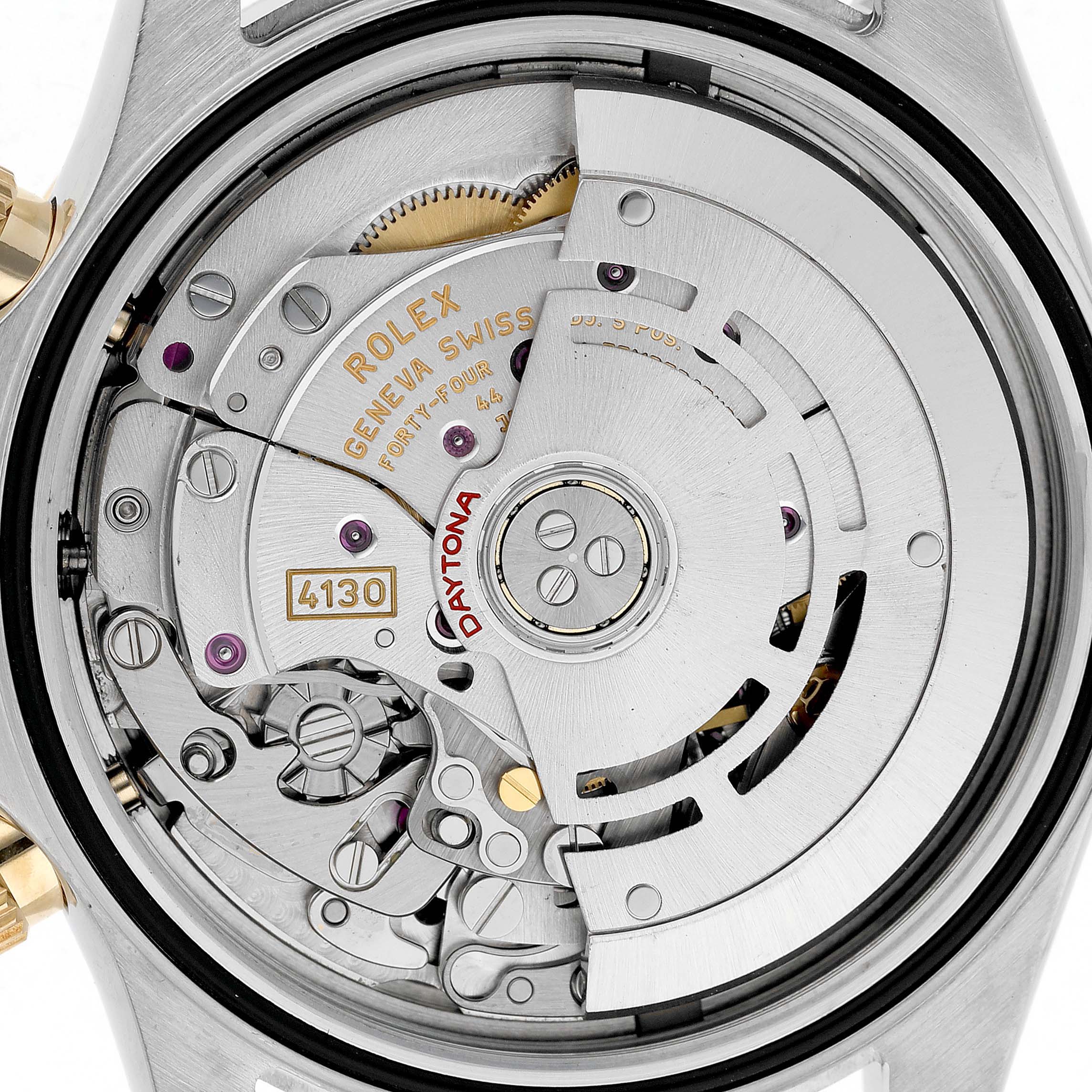 The image shows a detailed close-up of the Rolex Daytona 116523 Men's Steel and Gold (two tone) Silver Dial's movement from the back, highlighting its intricate mechanical components.