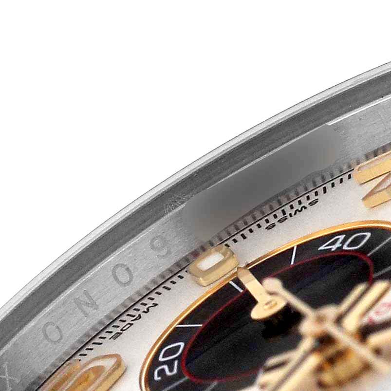 The image shows a close-up of the bezel, dial, and part of the sub-dials of a Rolex Daytona 116523 Men's Steel and Gold (two tone) Silver Dial watch.