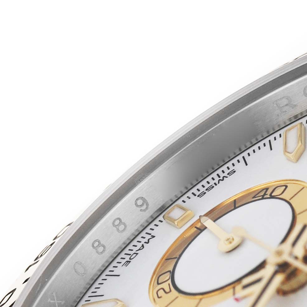 The image shows a close-up of the bezel and part of the dial of a Rolex Daytona M126503-0001 Men's Steel and Gold (two tone) White Dial watch, highlighting the tachymetric scale and subdial.