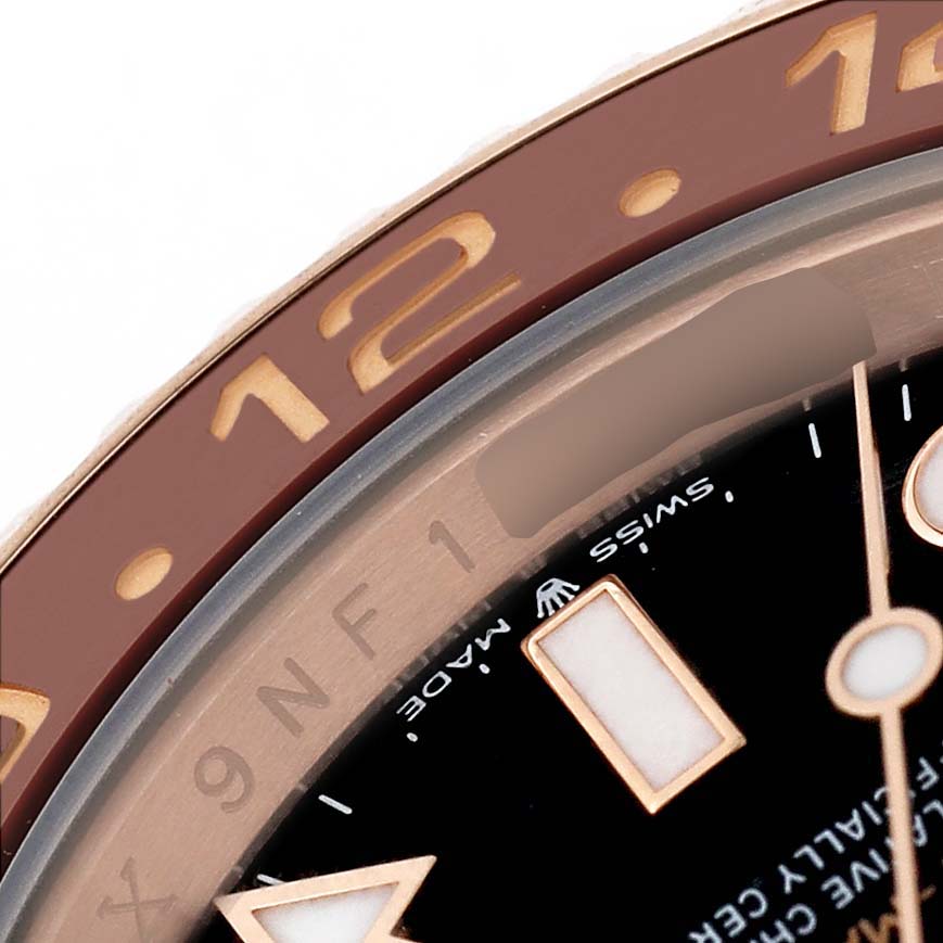 The image shows a close-up of the dial and bezel of a Rolex GMT-Master 126715 Men's Rose Gold Black Dial, highlighting numbers and markers.