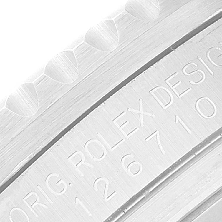 This close-up image shows the engraved bezel and serial number of a Rolex GMT-Master 126710BLRO Men
s Stainless Steel Black Dial 126710BLRO Men
s Stainless Steel Black Dial watch.