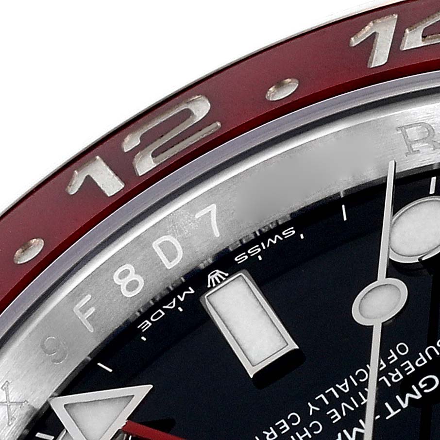 This close-up shot of the Rolex GMT-Master 126710BLRO Men
s Stainless Steel Black Dial 126710BLRO Men
s Stainless Steel Black Dial watch shows the bezel and part of the dial including hour markers and hands.