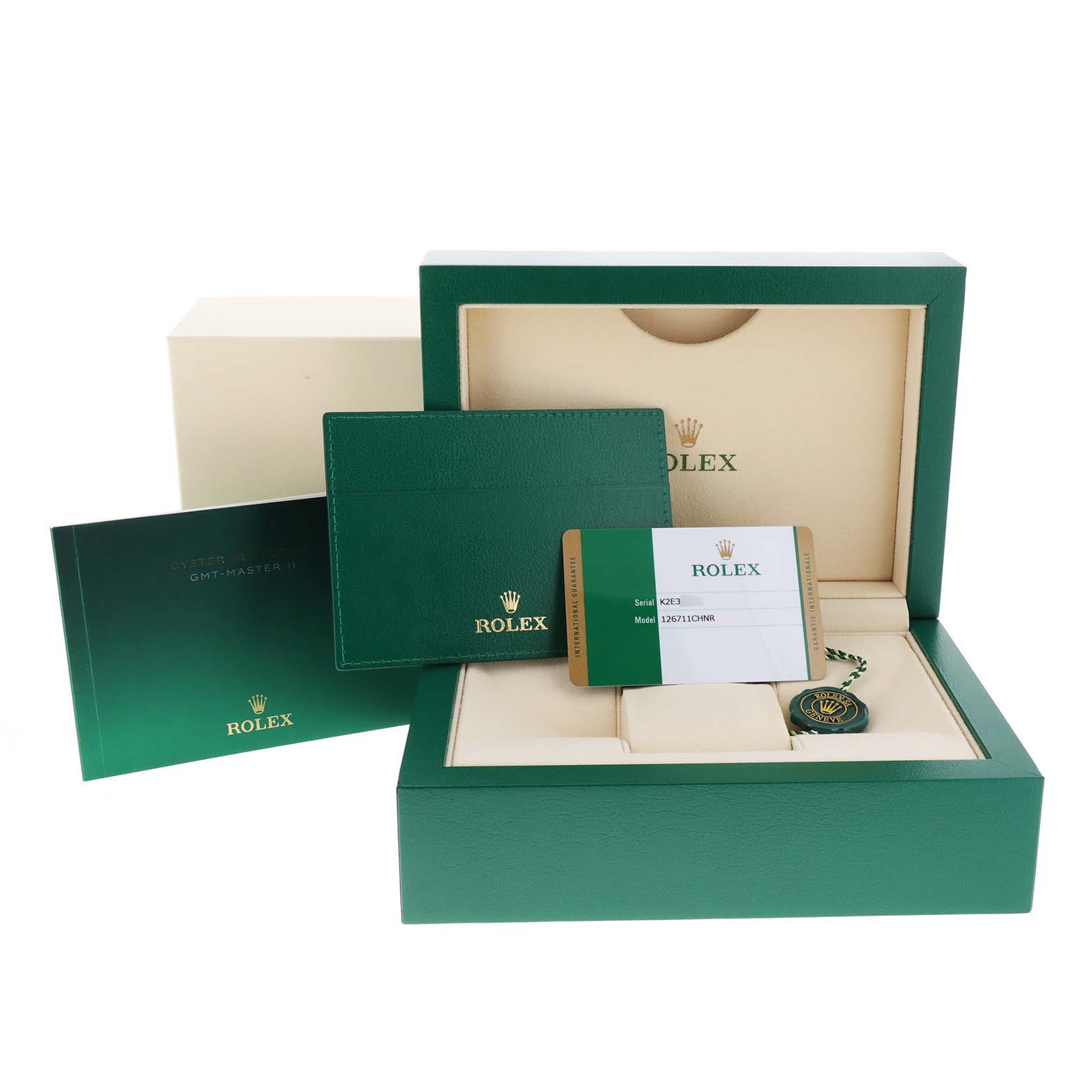 The image shows the packaging and accessories for a Rolex GMT-Master 126711CHNR Men's Steel and Gold (two tone) Black Dial 126711CHNR Men's Steel and Gold (two tone) Black Dial watch, including the presentation box, warranty card, and booklet.