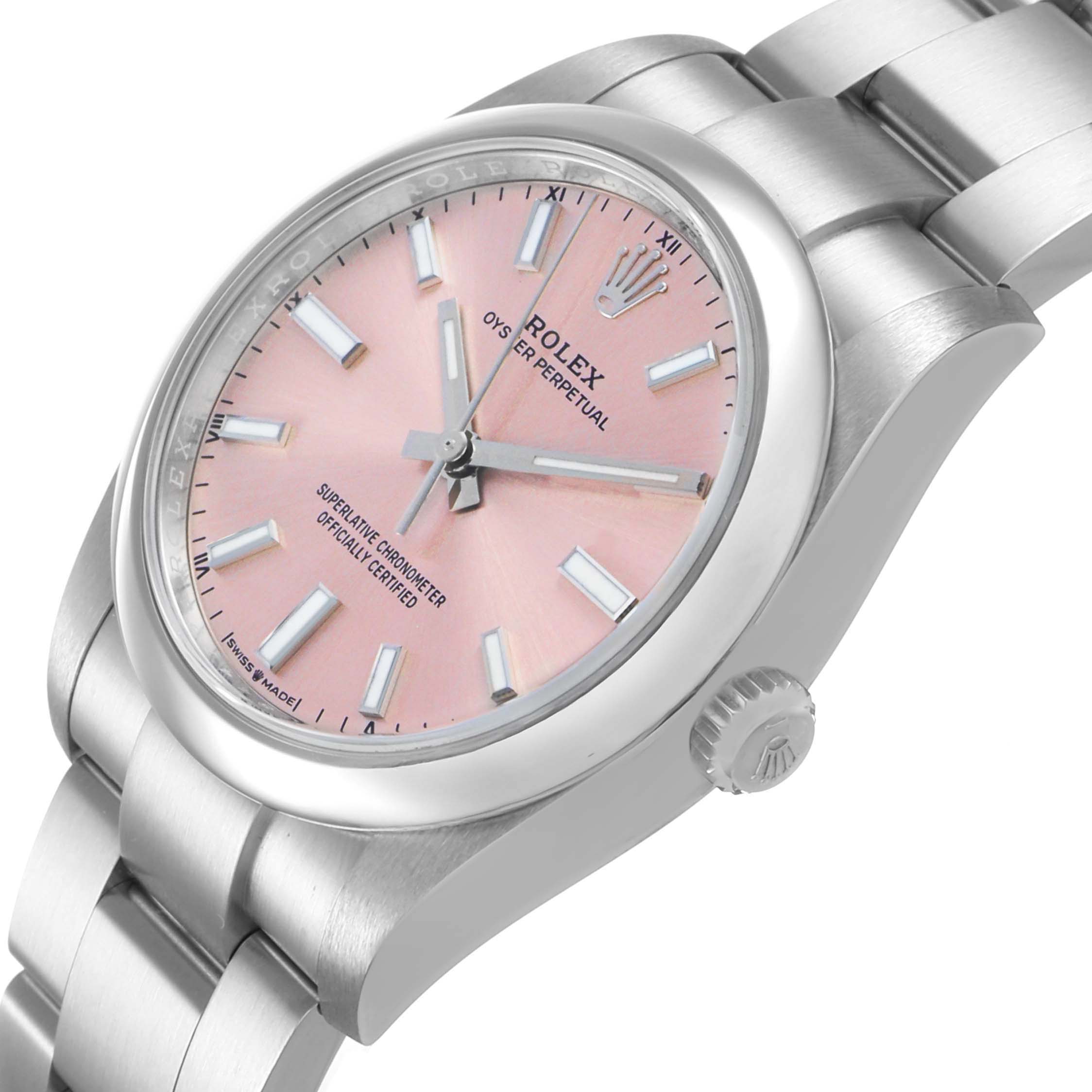 The image shows a side angle of the Rolex Oyster Perpetual 124200 Men's Stainless Steel Pink Dial watch, highlighting the pink dial, crown, and bracelet.