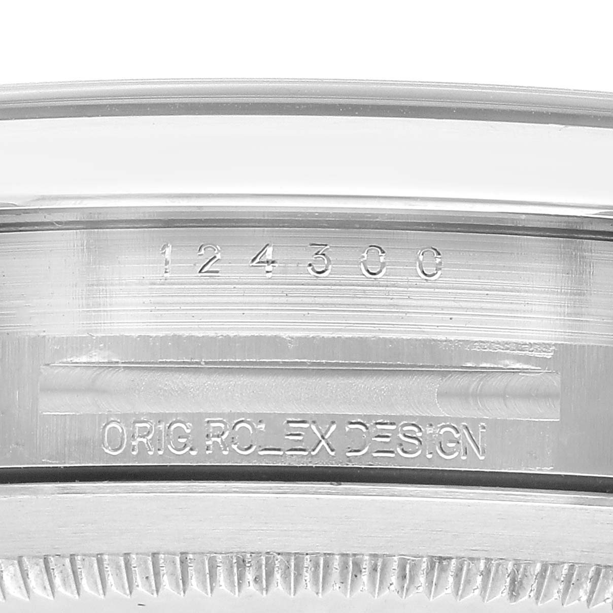This image shows a close-up of the case side of a Rolex Oyster Perpetual 124300 Men's Stainless Steel Green Dial, featuring the model number and "ORIG ROLEX DESIGN" engraving.