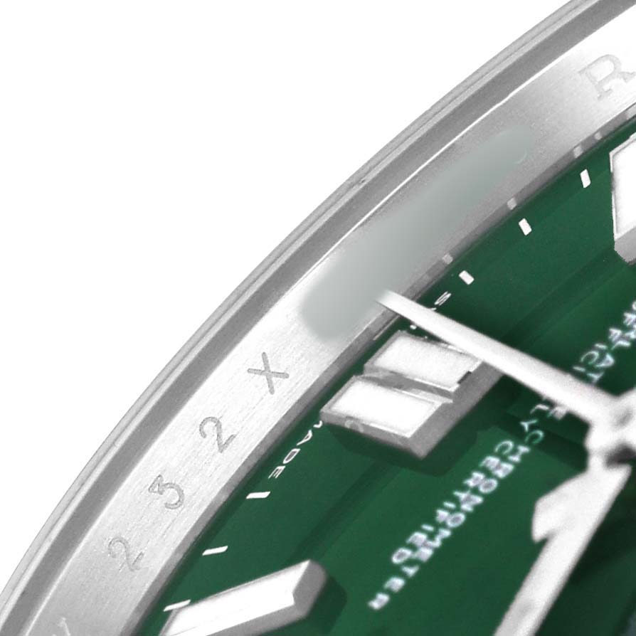 The image shows a close-up of the Rolex Oyster Perpetual 124300 Men's Stainless Steel Green Dial's green dial, bezel, and part of the hands.