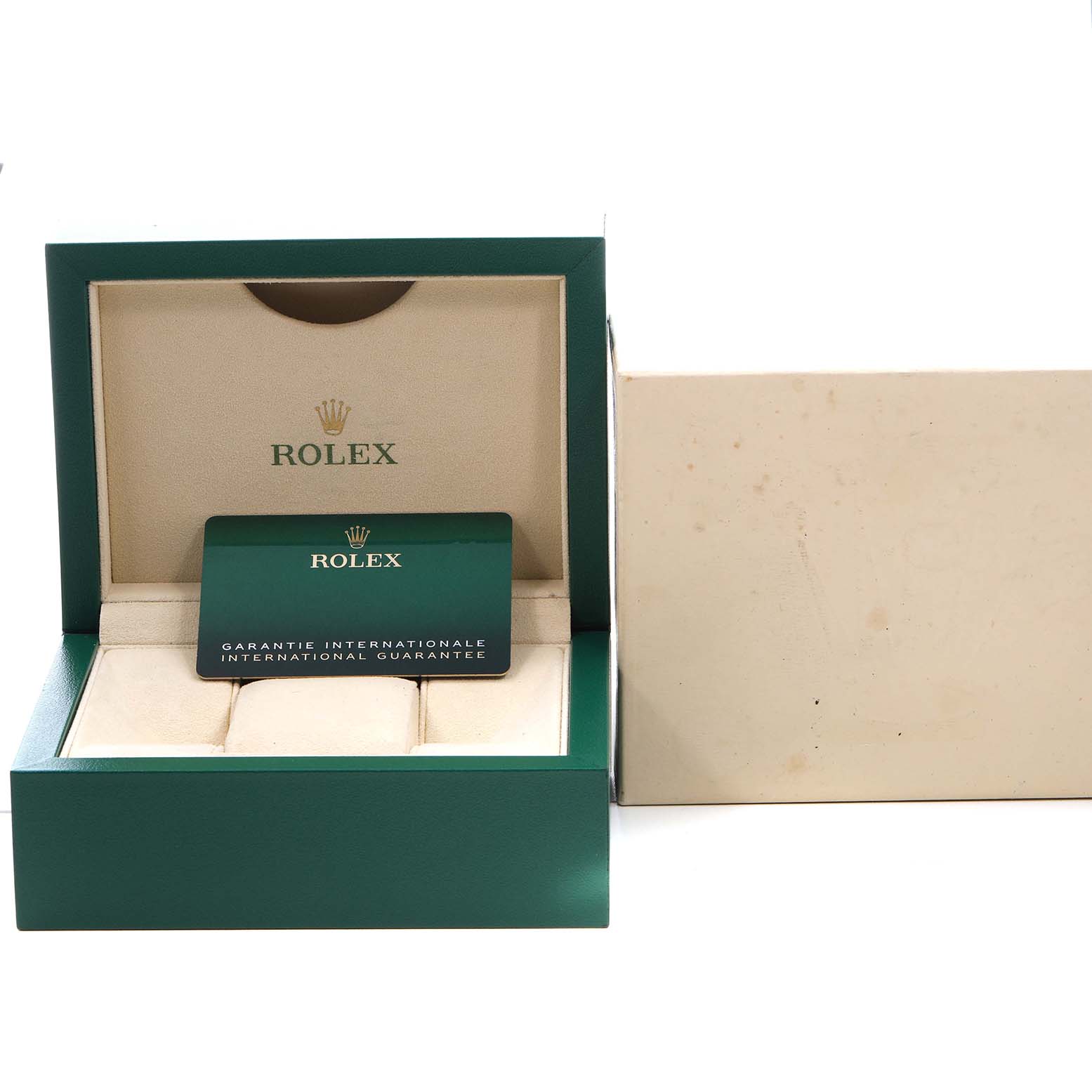 The image shows an open Rolex box for the Oyster Perpetual model, displaying the international guarantee card.