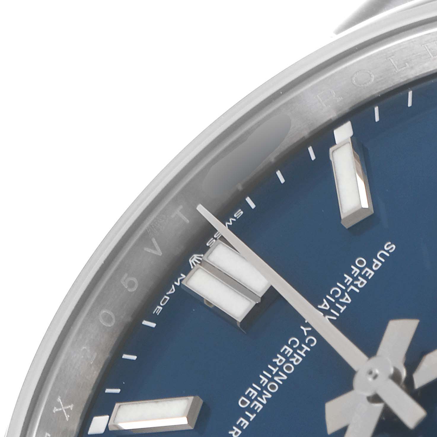 The image shows a close-up of the dial and part of the bezel of a Rolex Oyster Perpetual 124300 Men
s Stainless Steel Blue Dial 124300 Men
s Stainless Steel Blue Dial watch, highlighting the indices and markings.