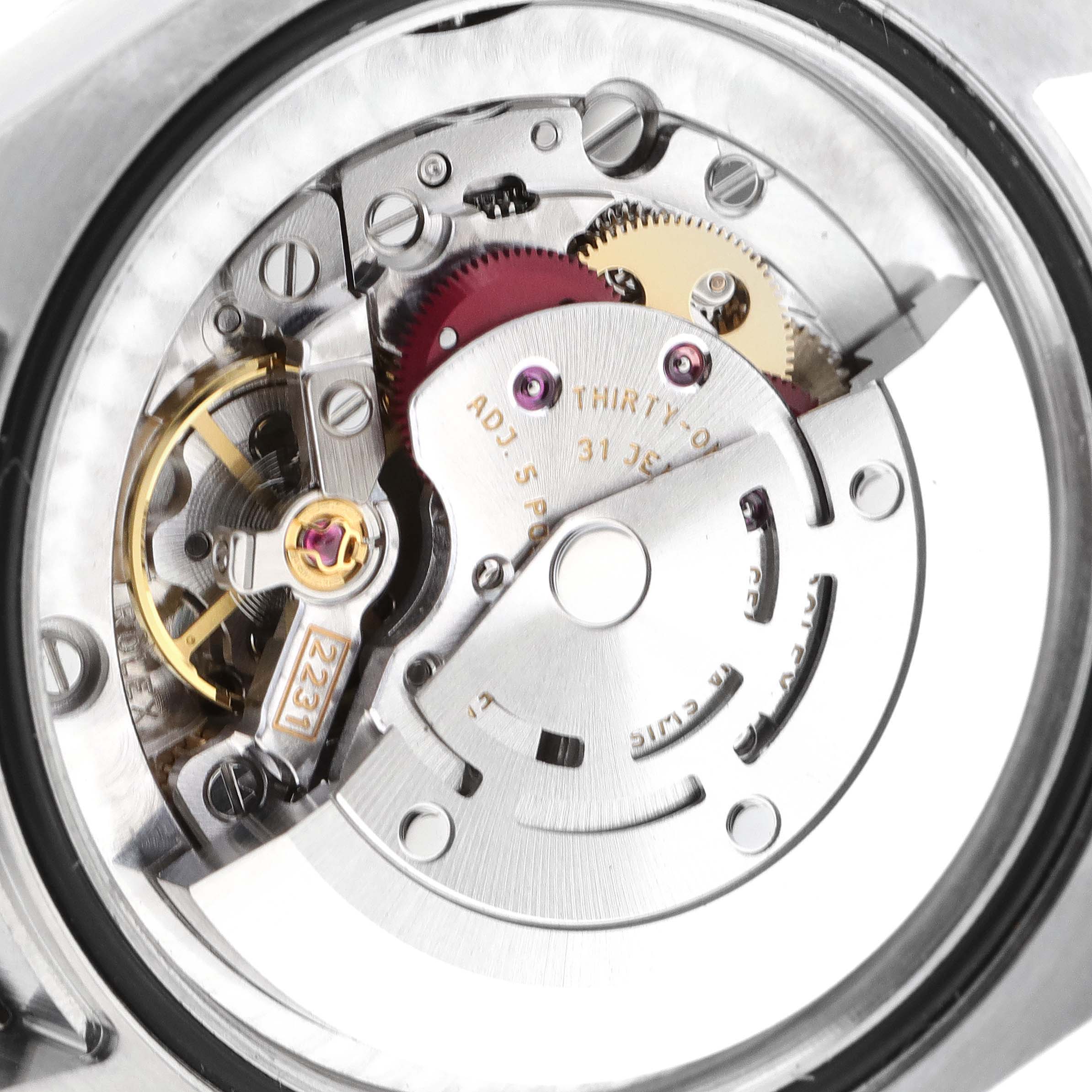 This image shows the internal mechanism of a Mid-Size Rolex watch from an angled close-up view.
