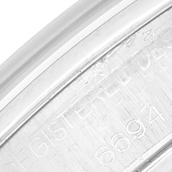 The image shows a close-up view of the engraved serial number on the back casing of a Rolex Vintage Collection 6694 Men's Stainless Steel Silver Dial 6694 Men's Stainless Steel Silver Dial watch.