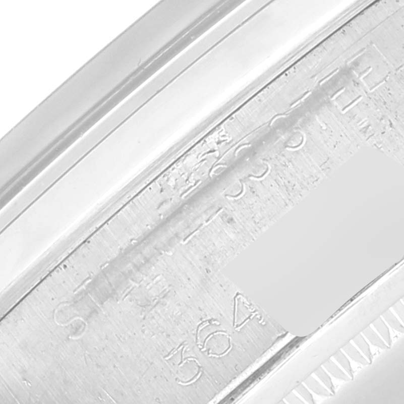 This close-up image of the Vintage Collection Rolex watch shows its engraved serial and reference numbers on the case.