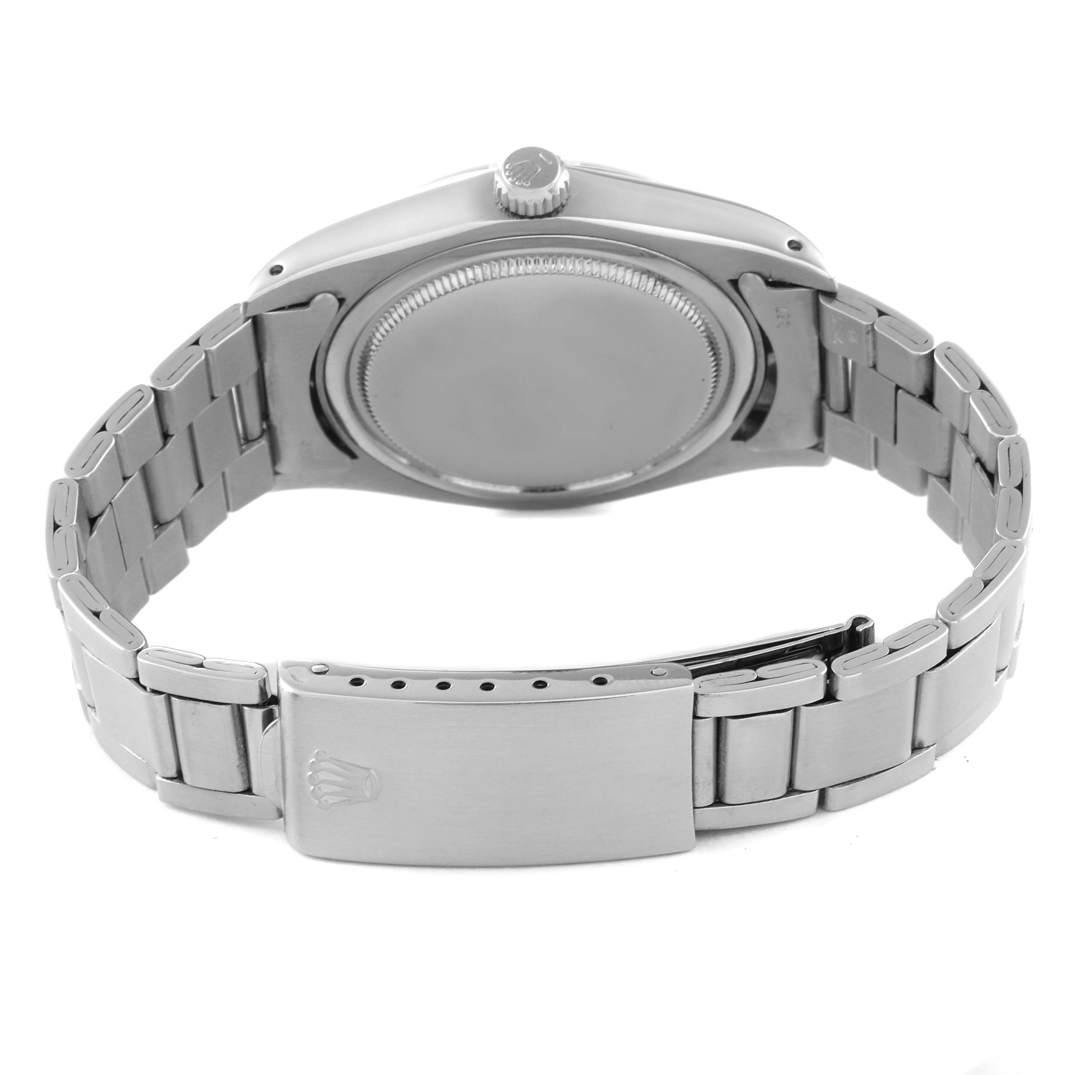 The image shows the back view of a Vintage Collection Rolex watch, highlighting its case back, crown, and metal bracelet with clasp.