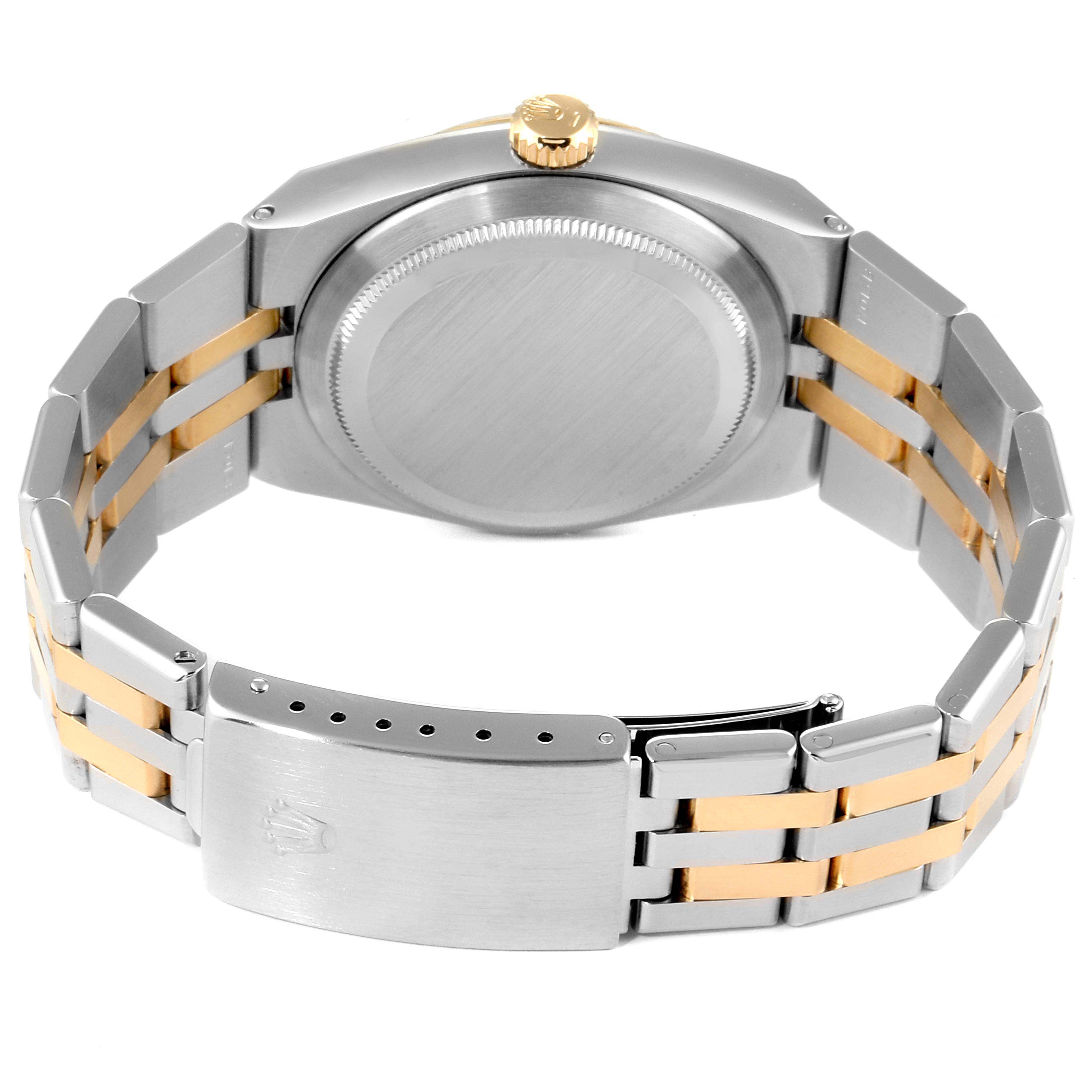 The image shows the back of a Rolex Oysterquartz 17013 Men
s Steel and Gold (two tone) Champagne Dial 17013 Men
s Steel and Gold (two tone) Champagne Dial watch, highlighting its case, crown, and two-tone metal bracelet with clasp.