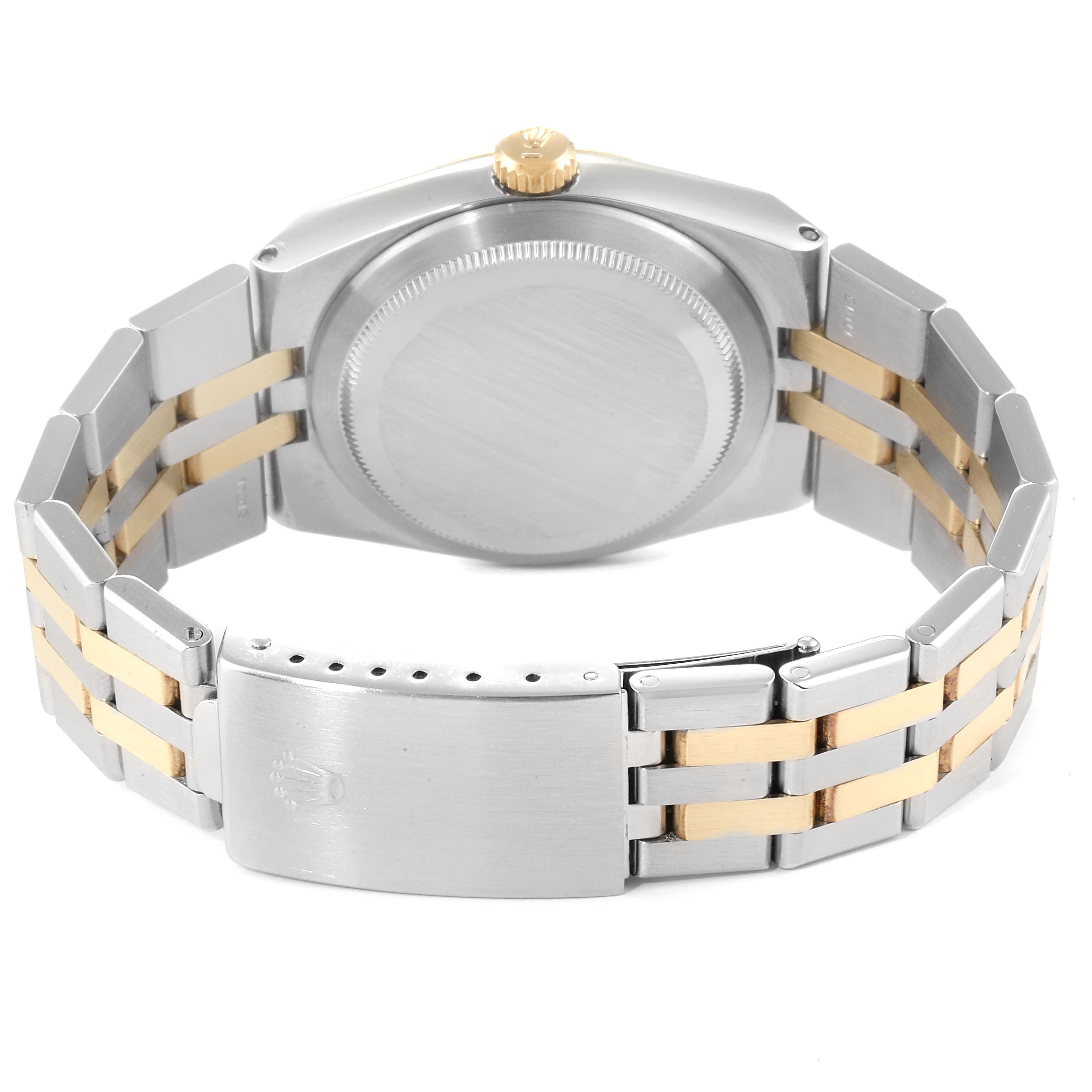 The image shows the back view of a Rolex Oysterquartz 17013 Men
s Steel and Gold (two tone) Silver Dial 17013 Men
s Steel and Gold (two tone) Silver Dial watch, highlighting its bracelet and clasp.