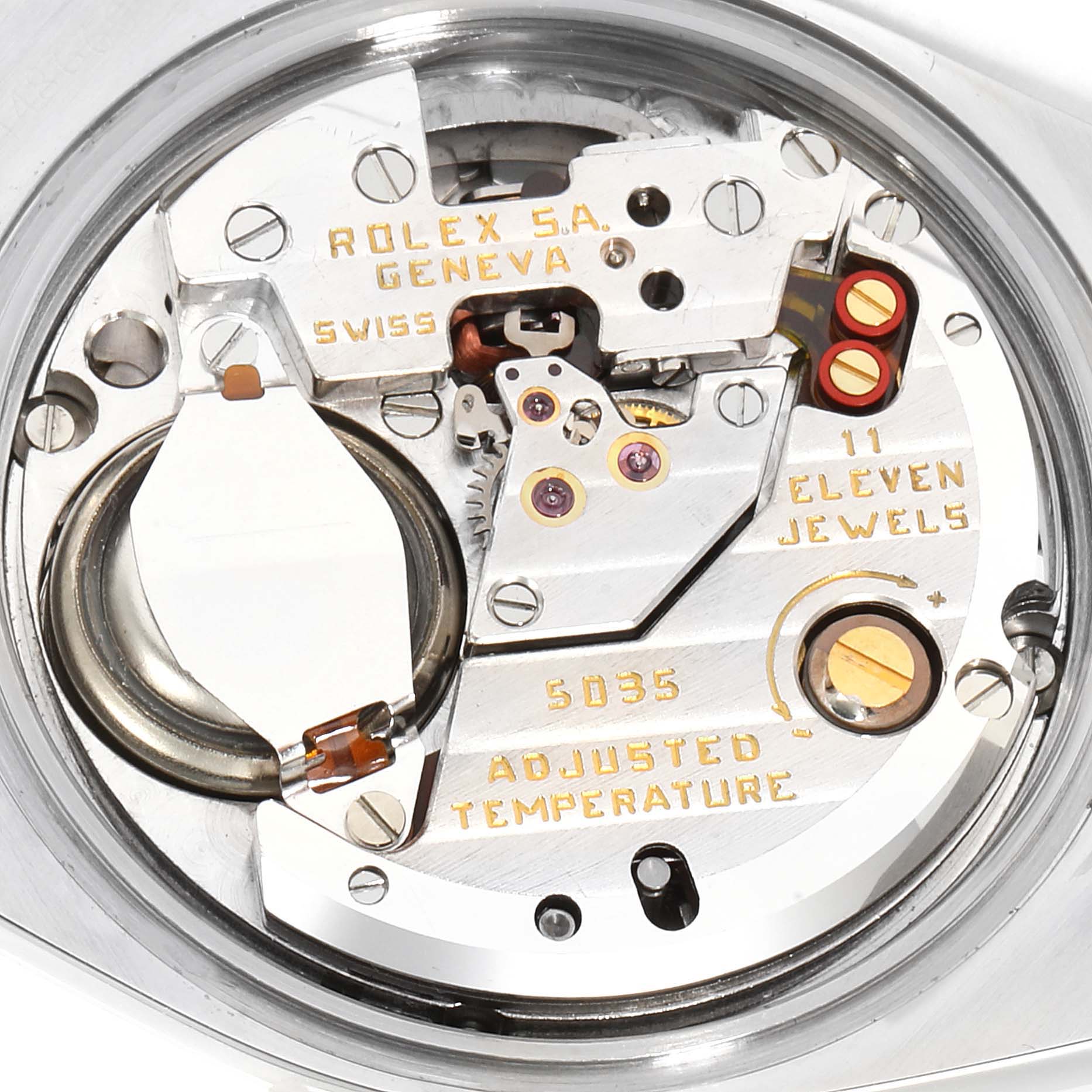 The image shows a close-up of the internal mechanism of a Rolex Oysterquartz 17013 Men's Steel and Gold (two tone) Champagne Dial 17013 Men's Steel and Gold (two tone) Champagne Dial watch, highlighting gears and inscriptions.