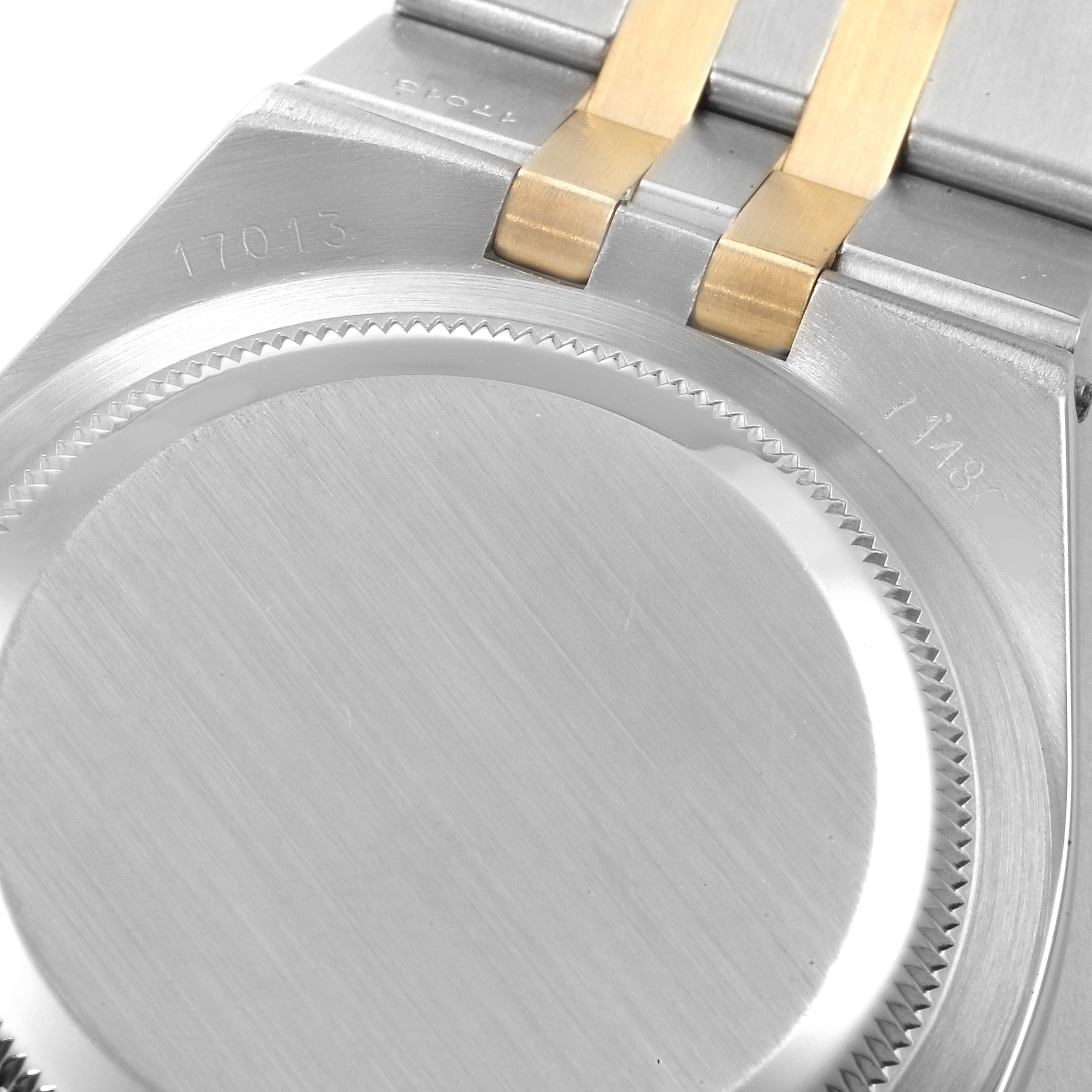 The image shows the back case and part of the bracelet of a Rolex Oysterquartz 17013 Men's Steel and Gold (two tone) Champagne Dial 17013 Men's Steel and Gold (two tone) Champagne Dial model.