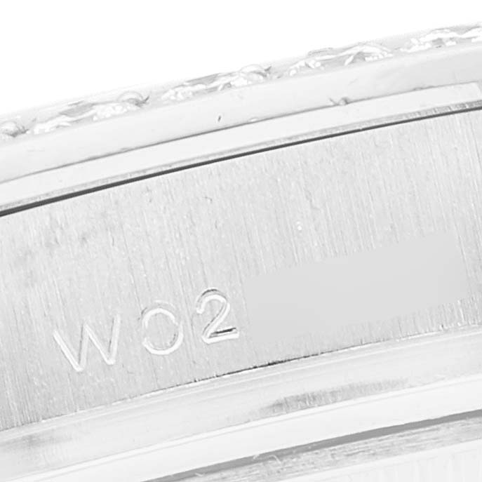 The image shows a close-up view of the side of the Rolex Pearlmaster 69299 Women's White Gold Silver Dial 69299 Women's White Gold Silver Dial watch, displaying part of the bezel and engraved serial number.