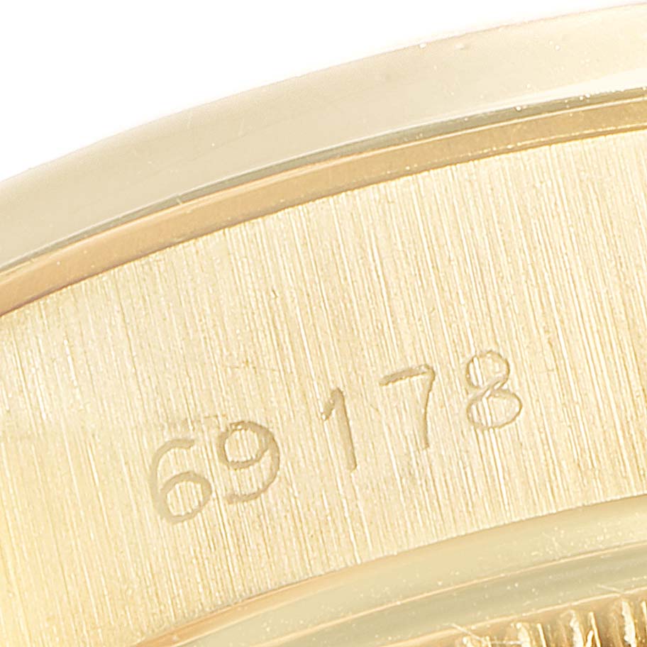 The image shows a close-up of the serial number engraved on the gold case of the Rolex President 69178 Women
s Yellow Gold Champagne Dial 69178 Women
s Yellow Gold Champagne Dial model watch.